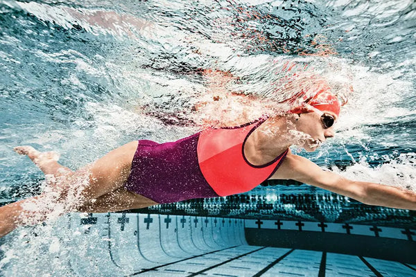 Woman swimming in the pool wearing a practice swimsuit