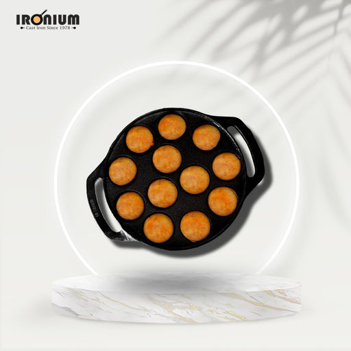 https://cdn.shopify.com/s/files/1/0612/0557/7945/products/ironium-cast-iron-pre-seasoned-round-heavy-paniyarakkal-12-pits-with-2-side-handle-196996_512x512.jpg?v=1689403500