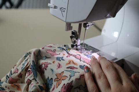 Stitching in the armband to the armhole on the top.