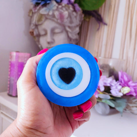 Womans hand holding the evil eye soap