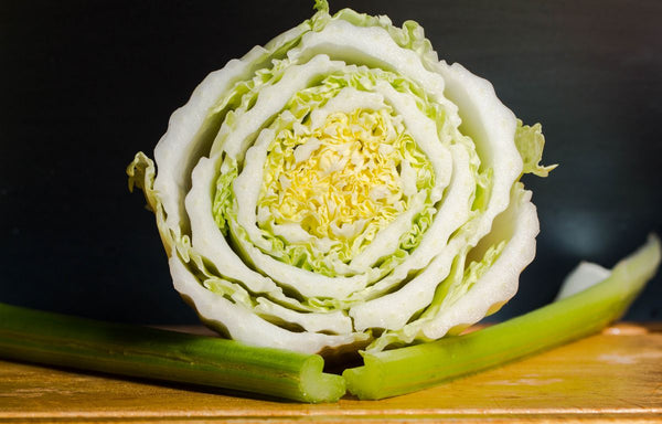 A celery bunch that has been cut open, showcasing the bulb of the vegetable