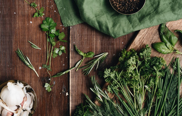 An aerial shot of different types of herbs on a benchtop