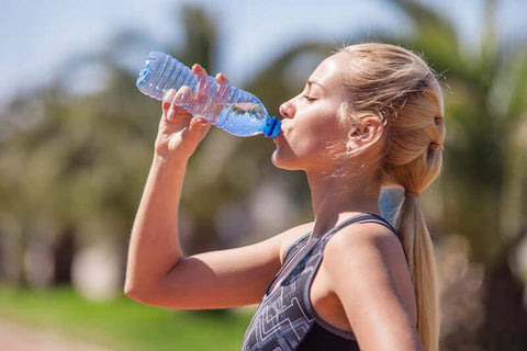 hydration-pack-running-young-blonde-girl-drinking-water