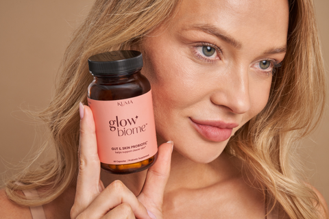 woman holding Glow Biome probiotics for skin health