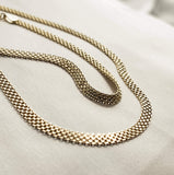 The debonair bracelet screams contemporary chic combined with edgy elegance. The bracelet has a unique texture because it rolls and folds, catching and reflecting the light. This piece is available in silver and gold and there is a chain to match. 