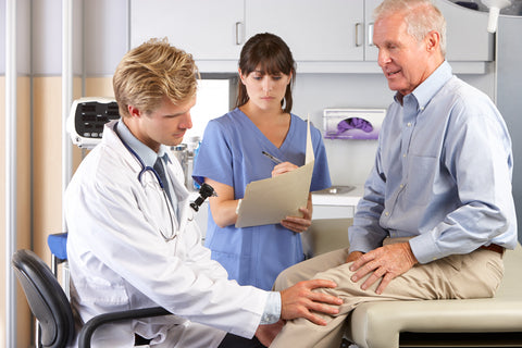 Doctor examining patient's knee joint