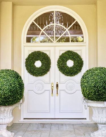 Artificial boxwood wreaths on front door