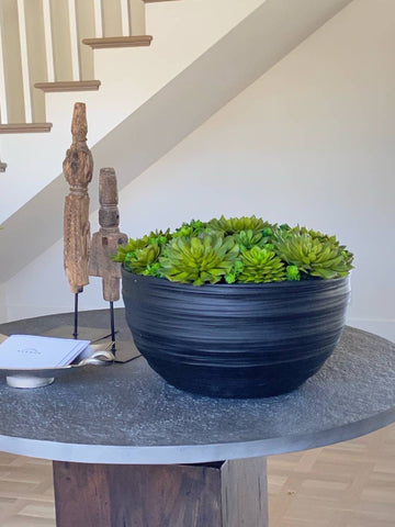 Large faux succulent in bowl on entryway table