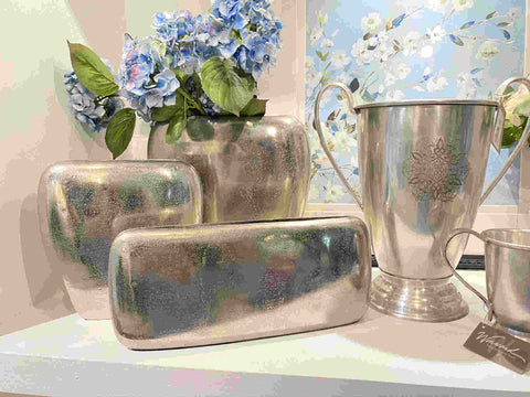 Display of metal decorative vases and containers