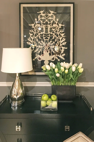Luxury lamp on a table to complement floral arrangement and artwork