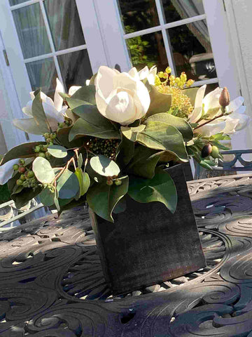 Luxury magnolia arrangement in container outdoors