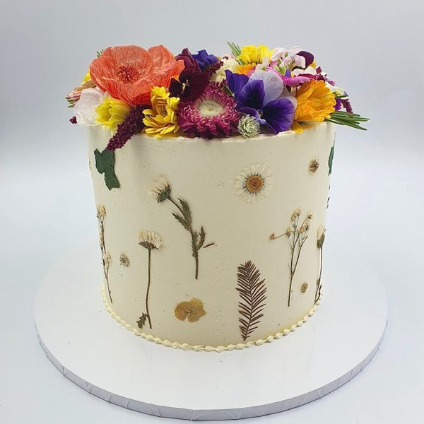 Edible dried and pressed flowers on a birthday cake