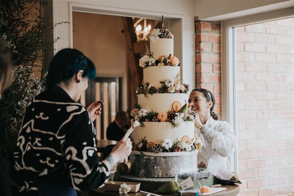 Pia and Dee setting up a Vanilla Pod Bakery Cake 