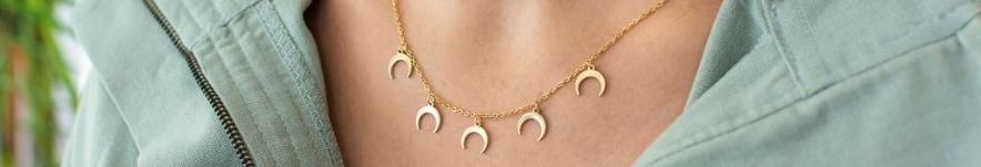 Close up of woman's neck wearing a crescent moon pendant necklace from James Jewelelry.