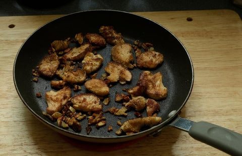 A pan with fried slices of lion's mane mushrooms.