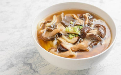 A bowl full of oyster mushroom soup.