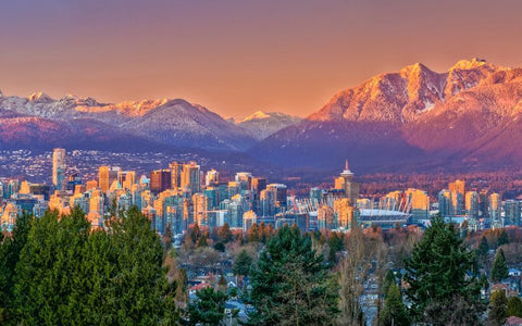 The skyline and mountains of Vancouver, BC seen from a high vantage point.