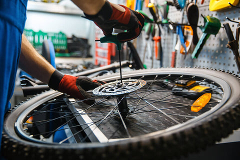 A person fixing a bicycle tire