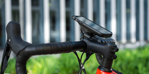 A bike phone mount securely attached to a mountain bike handlebar