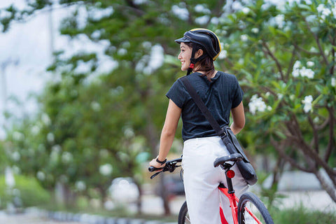 A woman on a bicycle who is smiling