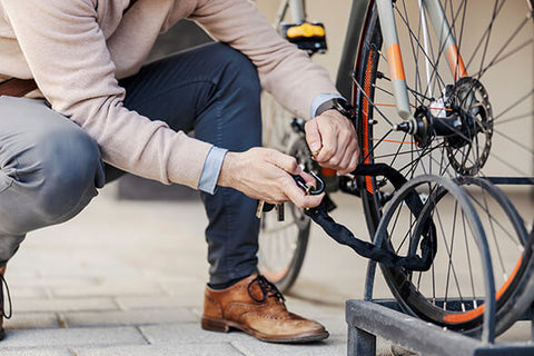 A cyclist locking their bike with a reliable bike lock