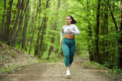 A person running outdoors to lose belly fat