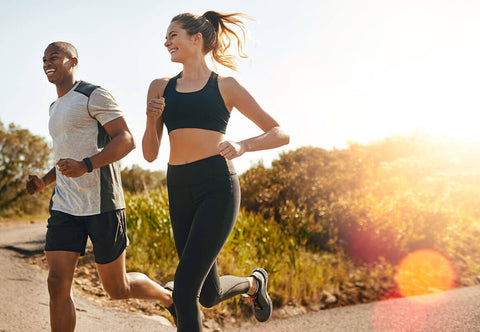 A man and a woman jogging outdoors