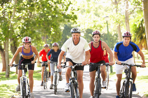 A group of cyclists who are all different ages enjoying the health benefits of cycling