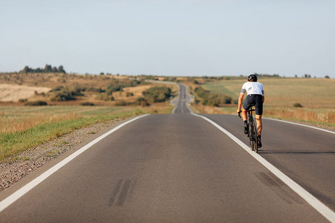 A cyclist riding a road bike on a long endurance ride