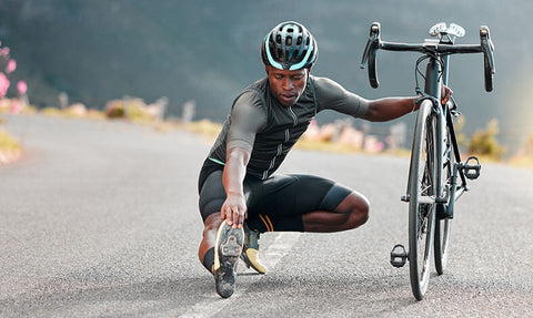A cyclist stretching after a ride to improve muscular strength and endurance