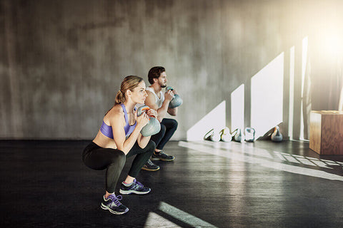 Cyclists performing weighted squats