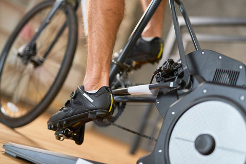 A cyclist using a power meter on their bike, setting their training zones based on their FTP