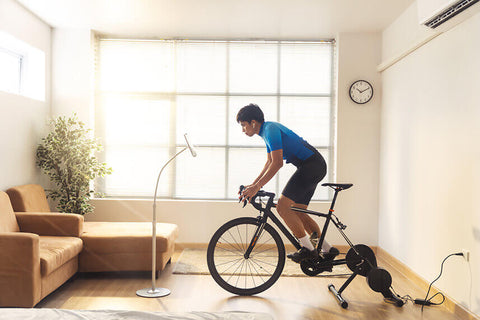 A cyclist training indoors on a bike during the winter months