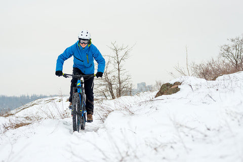 A cyclist in winter training gear, on a bike ride