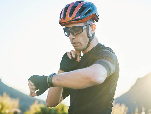 A cyclist riding a bike with a power meter and heart rate monitor, showing the power and heart rate zones