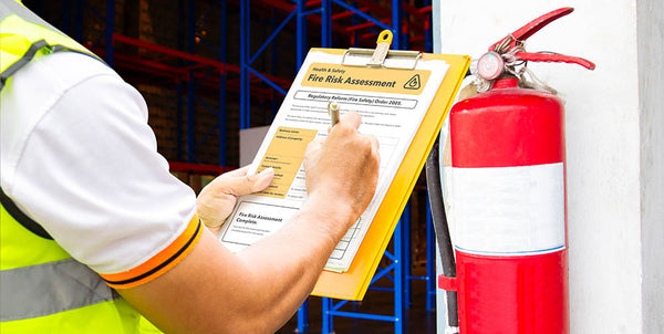 Worker conducting a fire risk assessment