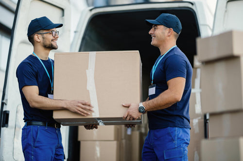 happy-manual-worker-cooperating-while-carrying-cardboard-boxes-delivery-van.jpg__PID:a3eb6c33-9293-4410-9bf6-352ba9a898f5