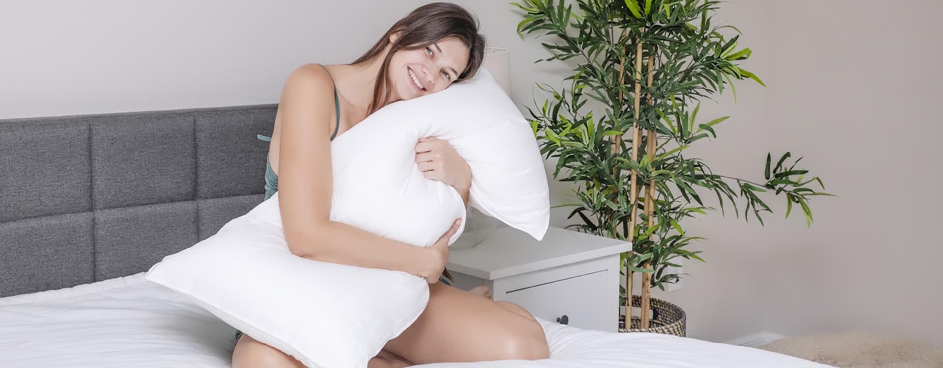 a woman and a man sitting on bed with bamboo sheet