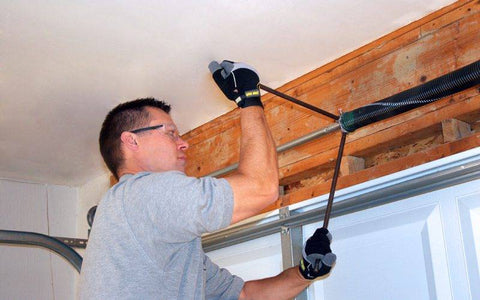 Person Fixing Garage Door Springs