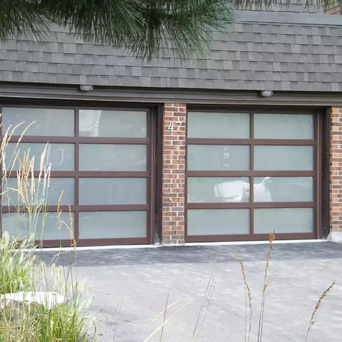 Double garage featuring a frosted garage door window with a contemporary design