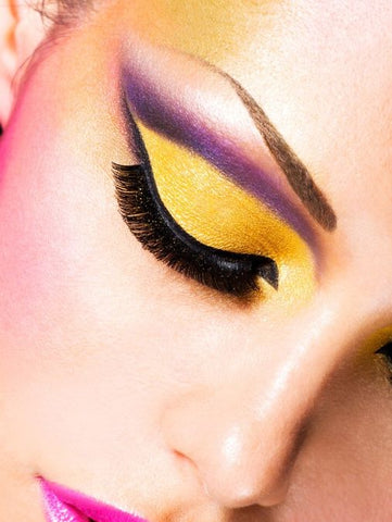 Yellow eyelids with purple eyeliner