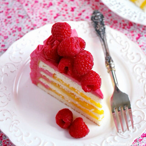 Raspberry Lemon Ruffle Cake is filled with light layers of cake, bright lemon curd, and covered in the best raspberry buttercream!