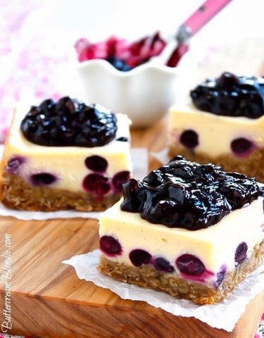 Classic cheesecake gets a sweet upgrade with fresh blueberries and bourbon. Baked on top of a cozy oatmeal cookie and topped with a lush blueberry compote, these cheesecake bars are always a hit!