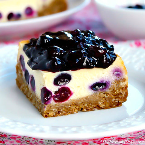 Classic cheesecake gets a sweet upgrade with fresh blueberries and bourbon. Baked on top of a cozy oatmeal cookie and topped with a lush blueberry compote, these cheesecake bars are always a hit!