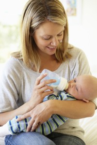 Mother bottle feeding baby