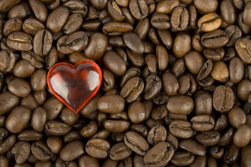 Many coffee beans with red heart