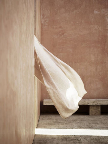 Photo of a linen curtain blowing in the breeze