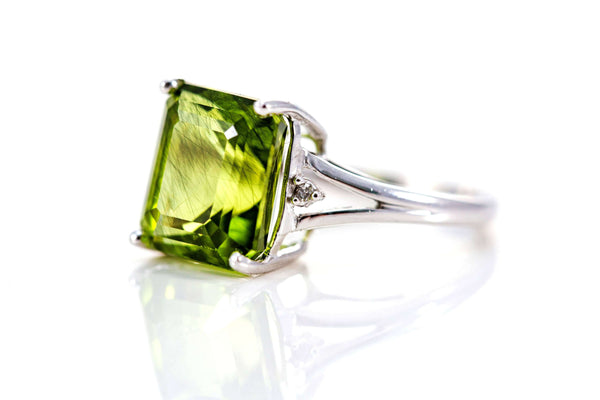 August birthstone ring with a green peridot stone.