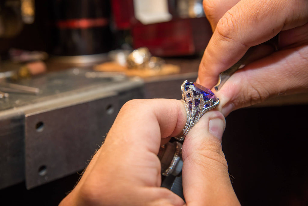 Jeweler setting a stone into a ring