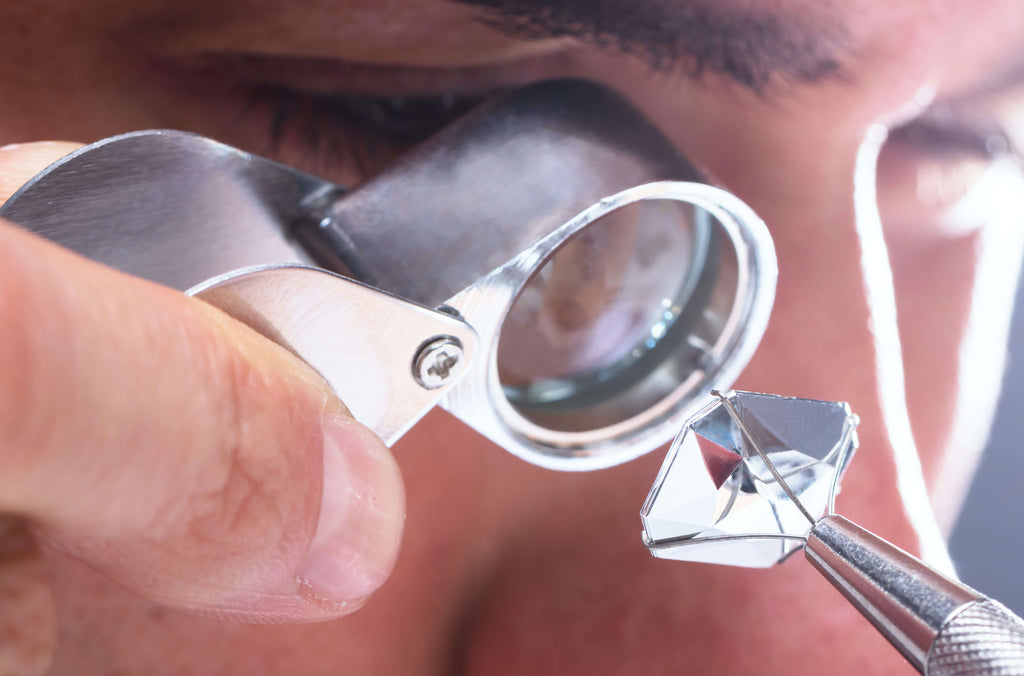 Jeweler inspecting the quality of a diamond